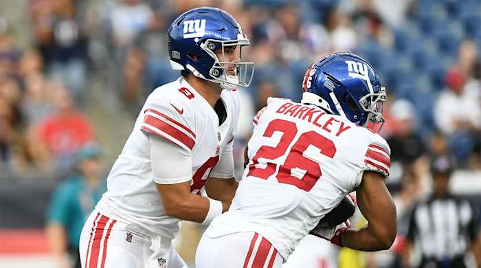 Aug 11, 2022; Foxborough, Massachusetts, USA; New York Giants quarterback Daniel Jones (8) hands the ball off to running back Saquon Barkley (26) during the first half of a game against the New England Patriots at Gillette Stadium.